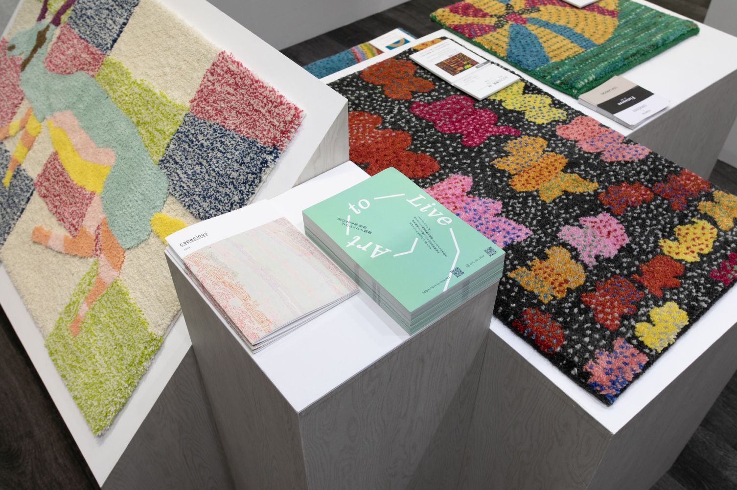 Interior view of the exhibition booth. Rugs are displayed.